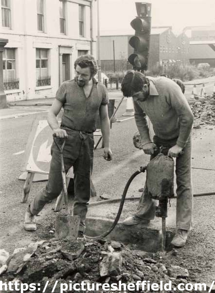 Workmen digging the road in unidentified location