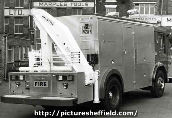 Fire engine with platform ladder, outside Marple Tools