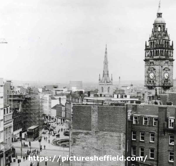 View of (left) Barkers Pool, (centre left) Fargate, (centre) side view of Town Hall Chambers and (right) Town Hall clock tower and rear of shops and businesses on Pinstone Street