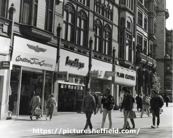 Shops on Fargate showing (l. to r.) No. 57 Western Jean Company, fashion store, No. 59 Bradleys, music shop, No. 61 Dr. Scholl, shoe shop and No. 63 Plain Clothes, fashion shop