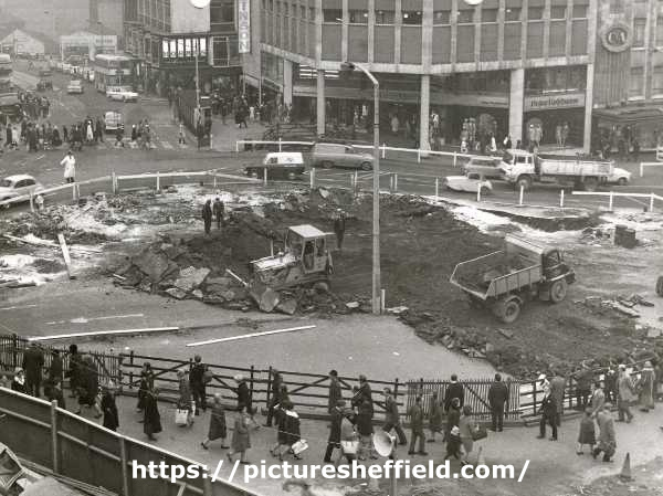 Excavations for central concourse for construction of Castle Square (also known as The Hole in the Road) showing (back centre) Peter Robinson Ltd., fashion department store and (top left) Angel Street and Horne Brothers Ltd., tailors, 1-3 King St. 