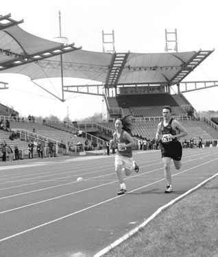 Competitors in one of the 3000m races at the Festival of Athletics, Don Valley Stadium, the athlete on the left is from Hallamshire Harriers