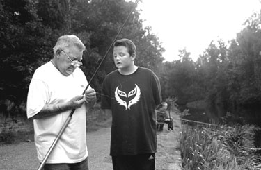 Alan Bradley and grandson Daniel Bradley fishing in the Canal (Sheffield and South Yorkshire Navigation) near near Pothouse Bridge, Coleridge Road