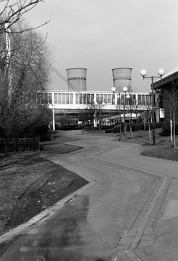 Five Weirs Walk Footpath alongside The Oasis with Footbridge from Transport Interchange to Meadowhall Shopping Centre and Tinsley Cooling Towers in the background