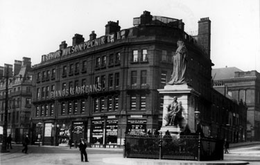 Town Hall Square and and Queen Victoria Memorial, looking towards Pinstone Street and Barkers Pool. Nos 2-6, Pinstone Street, Wilson Peck Ltd., Music Sellers, in background