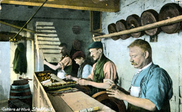 Cutlers at work buffing handles for cutlery