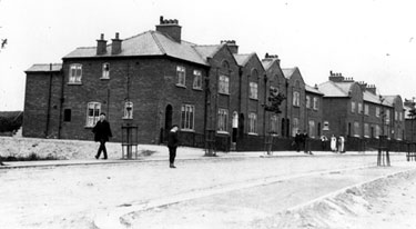 Maisonettes called The Terrace, Wincobank Avenue, Flower Estate, High Wincobank, backing on to a field excavated  for clay for the  brickworks on Shiregreen Lane and used in the building of the estate.