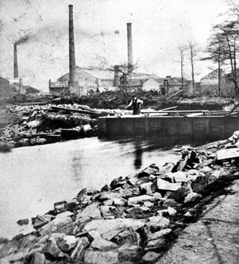 Sheffield Flood. Remains of the 'Shuttle House', residence of James Sharman, head of Bacon Island (formed by the River Don dividing into two branches), William and Samuel Butcher, steel tilters and rollers, Philadelphia Steel Works, in background