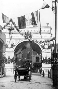 Visit of Queen Victoria, decorative arch at the junction of Broad Street and South Street, Park, photographed from South Street looking towards Broad Street, premises include Broad Street Cafe