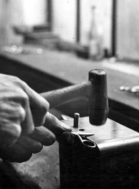 Cutlery manufacture, 'putting together' a pair of manicure scissors at Champion (Scissors) Ltd., Petre Street