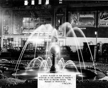 Floodlit fountain in City Hall Gardens, also known as Balm Green Gardens, Barker's Pool, during the Pageant of Production. Gaumont Cinema (formerly The Regent) in background