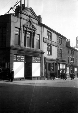 Shops on Barkers Pool prior to demolition for War Memorial, (left-right), No. 114 John Hoyland and Son, pianoforte dealers, No. 110 White Lion Hotel, No. 108 Mazzini Cadman, secondhand bookseller