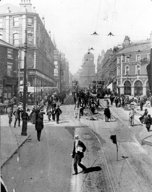 Re-laying the tram-tracks on Pinstone Street at Moorhead, Nelson Hotel, right (with flag), Roberts Brothers Ltd., left, St. Paul's in distance