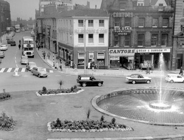 Town Hall Square looking towards Fargate and Leopold Street, Goodwin Fountain, foreground, No. 70 H.L. Brown and Son Ltd., jewellers, No. 68 Cantors Ltd., house furnishers, No. 66 Dean and Dawson Ltd., travel agents, Exchange Gateway