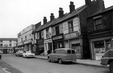Looking towards The Moor from Hereford Street, Nos. 1, 3 and 5 Era Furnishing Co. Ltd., house furnishers, on corner, No.  9 Strand Cafe, No. 11 Jn. Wm. Shaw and Son, bakers, No. 13 hairdressers, No. 15 Horace Willgoose, musical instrument dealers