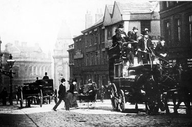 Horse drawn bus passing Market Place/High Street at corner with Change Alley, premises on right include Nos 78-80, former timber framed house, then occupied by John Wheeldon and Co, manufacturers of leather bands