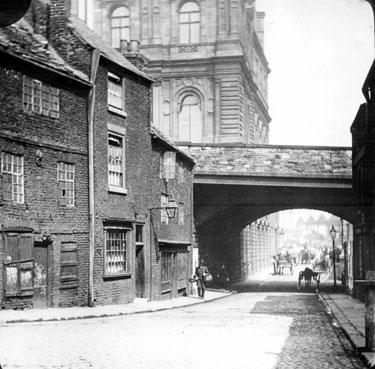 Shude Hill passing under Commercial Street Bridge, Gas Company Offices, in background