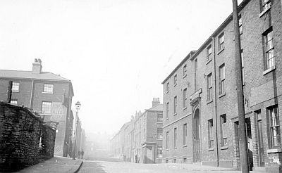 No. 222 Cooke and Stevenson Ltd, electrical engineers (formerly the Catholic Boys Hostel), Solly Street, corner of St. Vincent's Vicarage wall (left), No. 223, Hope and Anchor public house, corner of Red Hill (left), Corn Hill (right) looking towards