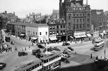 Town Hall Square and rockery, looking towards Leopold Street and Fargate, premises include No. 70 Fargate, H.L. Brown and Son Ltd., jewellers, No. 68 Cantors, No. 66 Dean and Dawson Ltd., travel agents and Bank Chambers