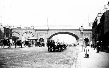 Horse drawn traffic in The Wicker with Great Central Railway steam engines travelling across the Wicker Arches