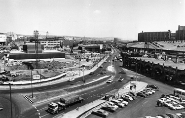 Elevated view of Sheaf Street with a new building for Hallam University under construction; Sheaf Valley Baths (centre), Park Hill Flats (right) and Sheffield Midland railway station foreground