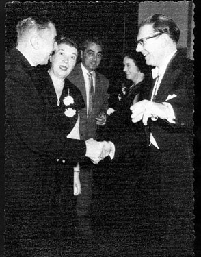 Mr. George W. Reddish, Manager of Classic Cinema meets  Mr Roy Raistrick, Manager of Gaumont Cinema at Cinema Trade Event. Reginald Dixon, Organist, in the background