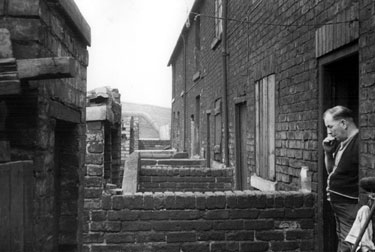 Mr. Vincent Lawrence Bryan in the doorway of No. 12 and Nos. 11 - 7, Canal Cottages, Tinsley Park Road, (demolished February 1958) looking towards Broughton Lane Bridge