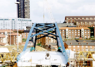 Construction of Park Square Supertram Bridge from Commercial Street, during the building of Supertram. Park area including the last remaining part of Hyde Park Flats, in background