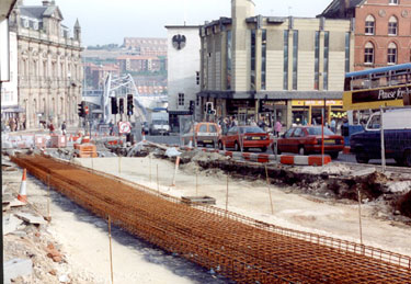 Bottom of High Street at Fitzalan Square, looking towards Commercial Street, during the construction of Supertram. Old Gas Company Offices, known as Canada House, on left, in background