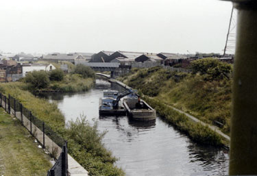 Dredging of the Sheffield and South Yorkshire Navigation viewed from Shirland Lane Bridge looking towards the Railway Bridge over the Canal  and Darnall Works in the background