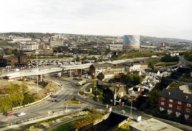 Elevated view of the construction of Supertram Viaduct, Park Square roundabout, Duke Street and Midland Railway Bridge in the foreground and Canal Basin before restoration (centre)