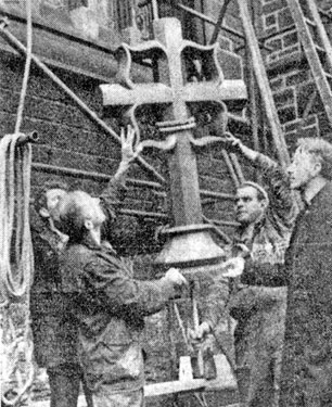 Canon G.P.Collins watches workmen lift the new cross up to the East Gable Cross of St. Marie's Roman Catholic Cathedral, Norfolk Row replacing the one blown down 4 years ago