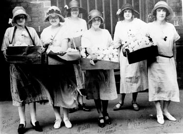 Girls handing white roses out as a promotion for the showing of the film 'The White Rose' at the Albert Hall 	