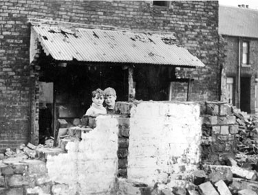 Children playing among the dereliction in an unidentified area