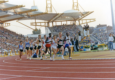 Eventual winner in a UK All Comers Record, No.11, Peter Elliott from Rotherham and second place Steve Cram (No. 1 on the outside) during the 1500m at the McVities Challenge, Don Valley Stadium