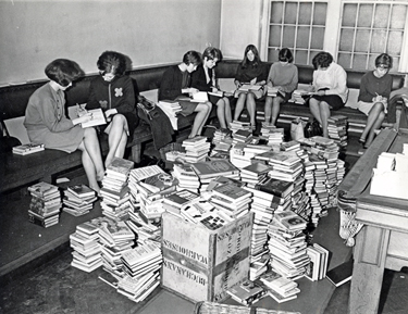 Librarians sorting a large amount of library books taken to Attercliffe Police Station, Whitworth Lane.