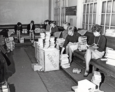 Librarians sorting a large amount of library books taken to Attercliffe Police Station, Whitworth Road. 