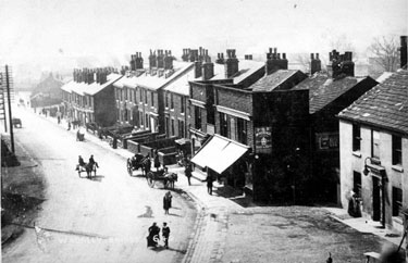 Elevated view of houses and shops, Penistone Road at Wadsley Bridge (photographed from railway bridge). New Inn, right