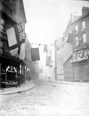 Market Place looking towards High Street, premises on right include No. 49 Market Place, John Lawton, jeweller and watchmaker. Premises on left include No. 68 Charles Butler, confectioner and No. 70 George Hotel