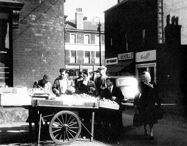 Fruit stall, Attercliffe Road with No. 648 Jn. W. Scott's, hairdressers; 650 John Shentall Ltd, grocer with Shirland Lane in the background