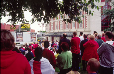 Fans watching the England vs. Brazil World Cup game on a large screen in Tudor Square