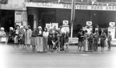 Crowds gathering outside Penistone Road Garage for the visit of Queen Elizabeth II to open the new Sheffield Wednesday stadium at Hillsborough