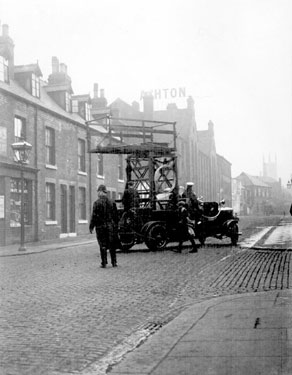 Sidney Street outside Thomas A. Ashton Ltd., looking towards Sylvester Street with St. Mary's, Bramall Lane in the background