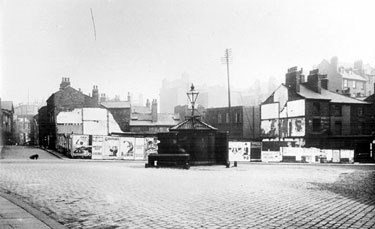 Barkers Pool looking towards Holly Street, left, and the 'Iron Man', from Cambridge Street, prior to the construction of the City Hall. Advertising hoardings are on the site of demolished Pool Place and buildings at Balm Green can be seen in the back