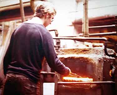 Worker at Jessop and Smith's Albert Works, Sidney Street annealing knife blades. 1970s. 