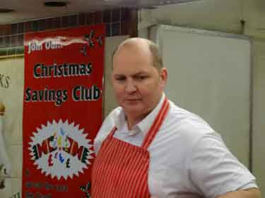 Market worker beside his Christmas Savings Club sign during the last days of Castle Market 
