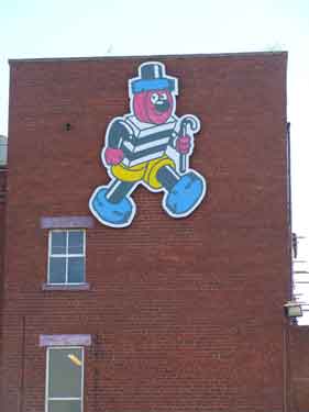 Bertie Bassett, the brand mascot of Cadbury Sheffield (formerly Geo. Bassett and Co.), confectionary manufacturers on the wall of their factory, Dutton Road