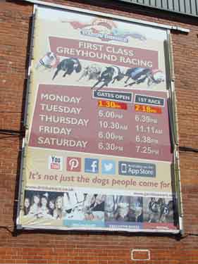 Advertising hoarding for greyhound racing in car park of Owlerton Stadium, Penistone Road