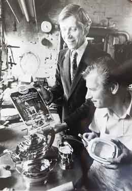 F. Drury (Silversmiths) Ltd., sales manager Bill Watkins and silver-plater Ted Hudson with a piece of silverware commissioned by Lyons Tea at Leah's Yard, mid 1970s