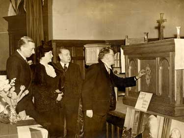 Sheffield Lord Mayor, (Alderman W. E. Yorke) examines some of the church furniture made in the SSAHS [Soldiers, Sailors and Airmen's Help Society] Workshops at Dundee [Angus, Scotland] at an exhibition held in Victoria Hall, Sheffield, c. 1948